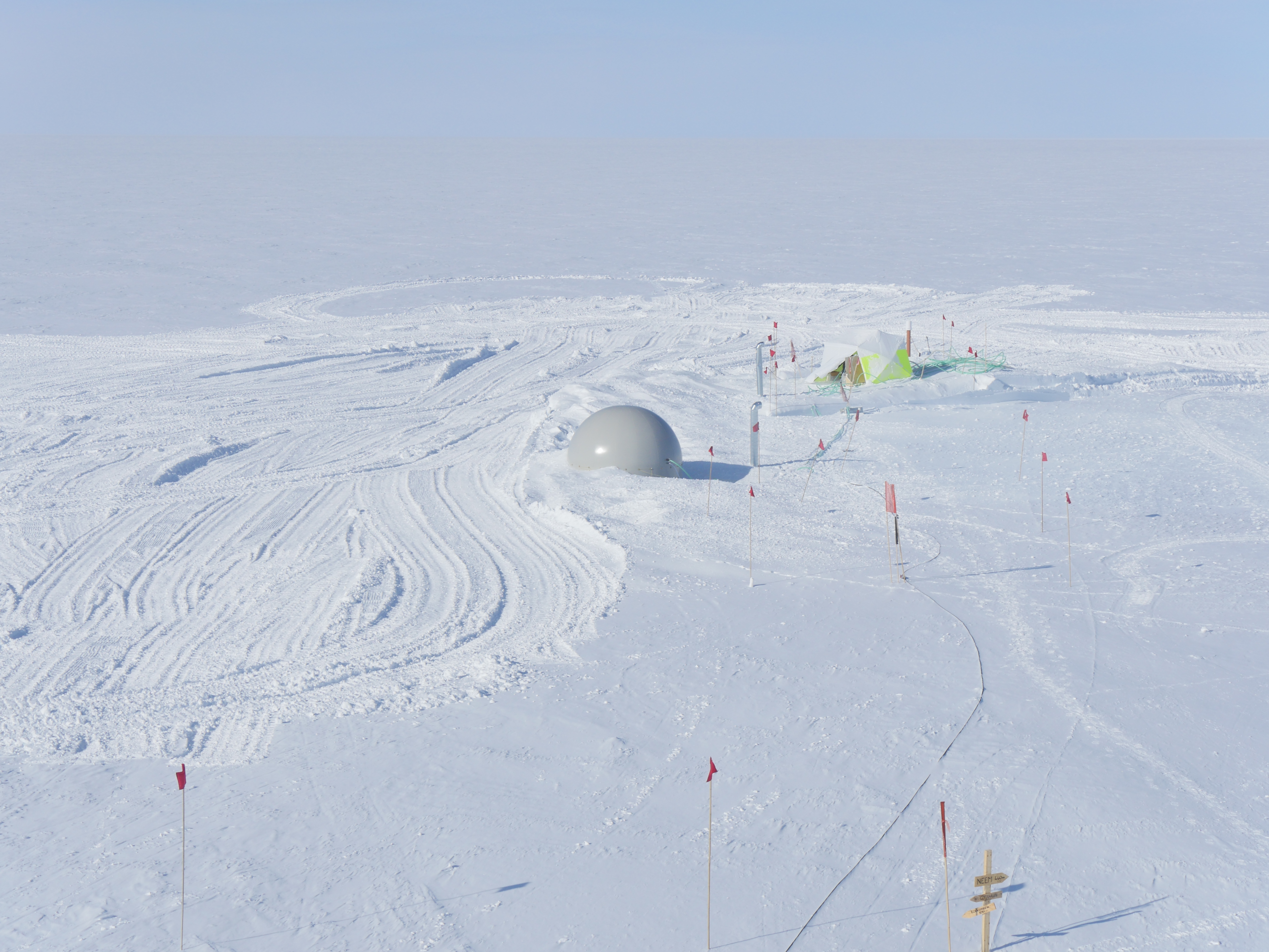 Only the access-hole balloon peeks up over the surface. The rest of the balloon have been covered with snow and the snow is now hardening