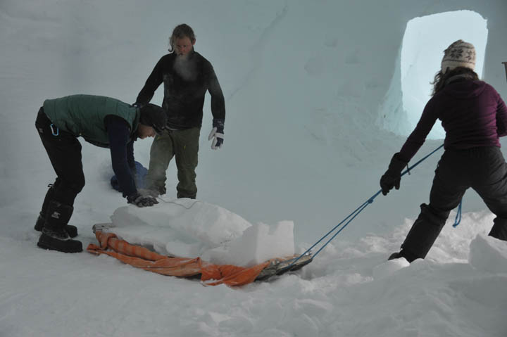 Trimming the trenches and moving the excess snow away is hard work