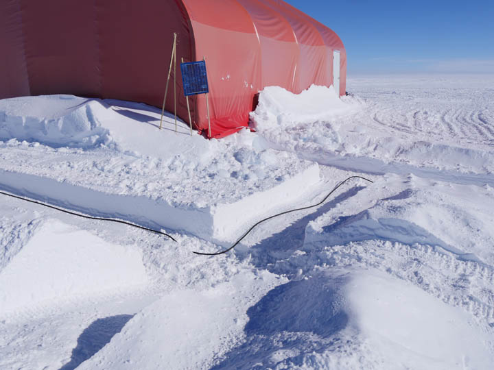 In order to protect the cables from passing vehicles, the cables are bundled up and placed in shallow trenches to be covered with snow.